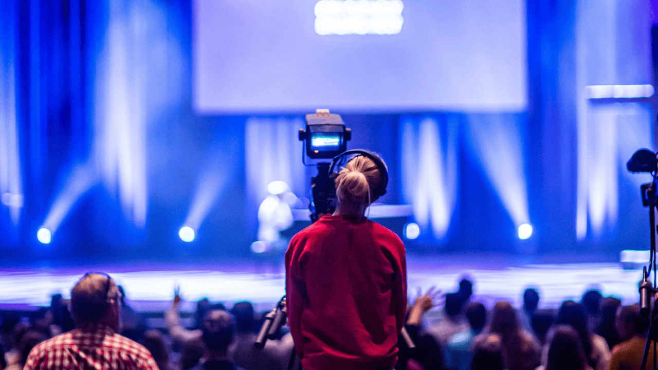 Large-scale Web3 event setup with stage, crowd, and branding visuals
